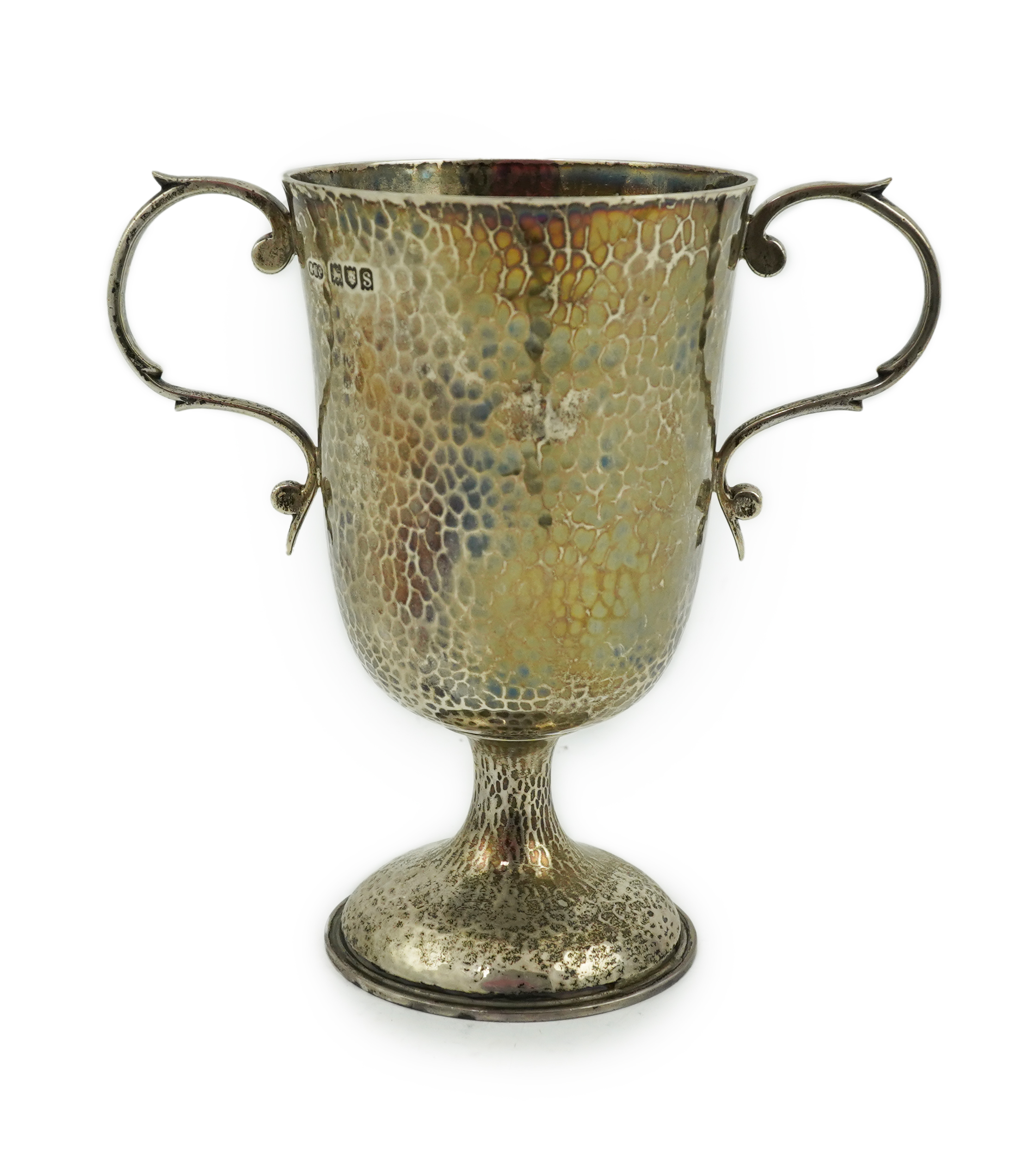 A George V planished silver two handled pedestal cup, by Henry Hodson Plante